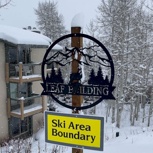 A snow-covered sign reads 